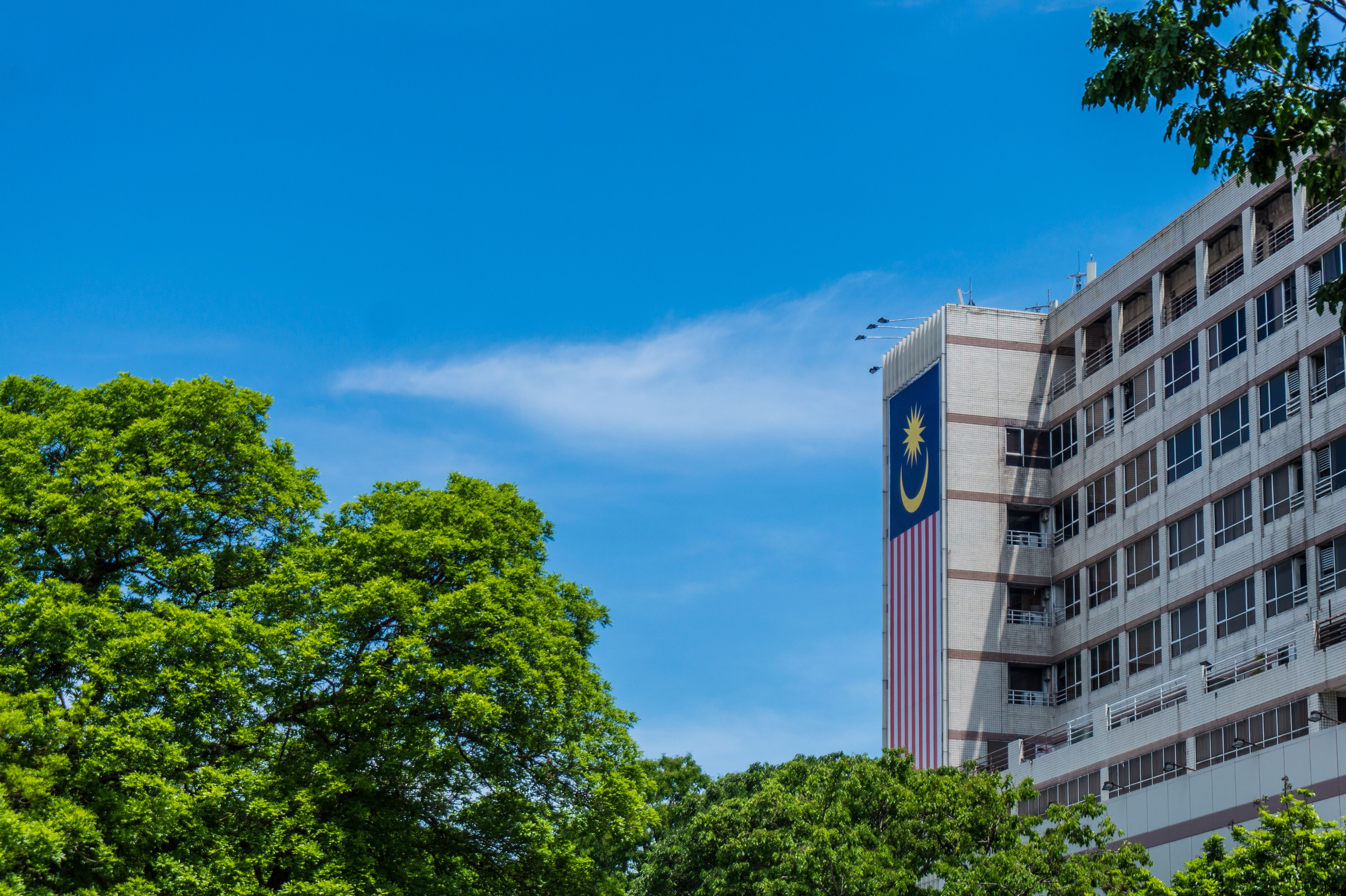 Modern building with the Malaysian flag and greenery in Kota Kinabalu, Sabah